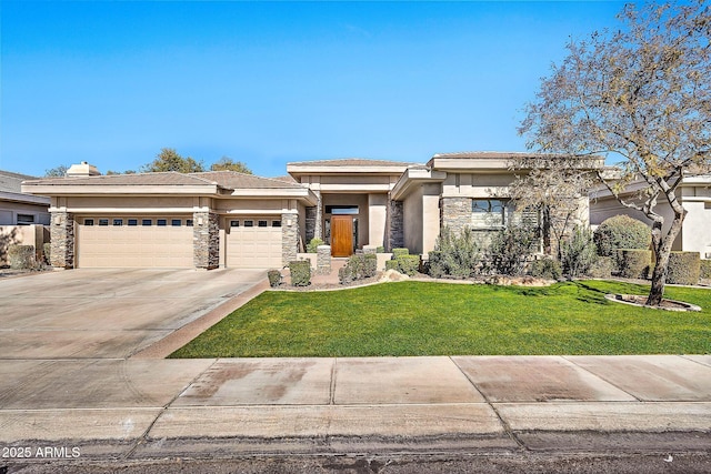 prairie-style home with a garage and a front lawn