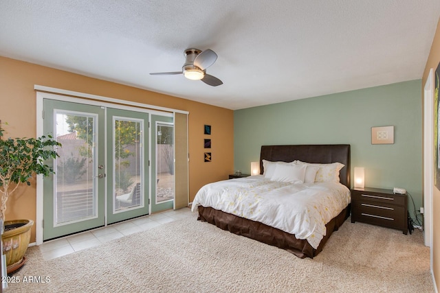 carpeted bedroom featuring ceiling fan, access to exterior, a textured ceiling, and french doors