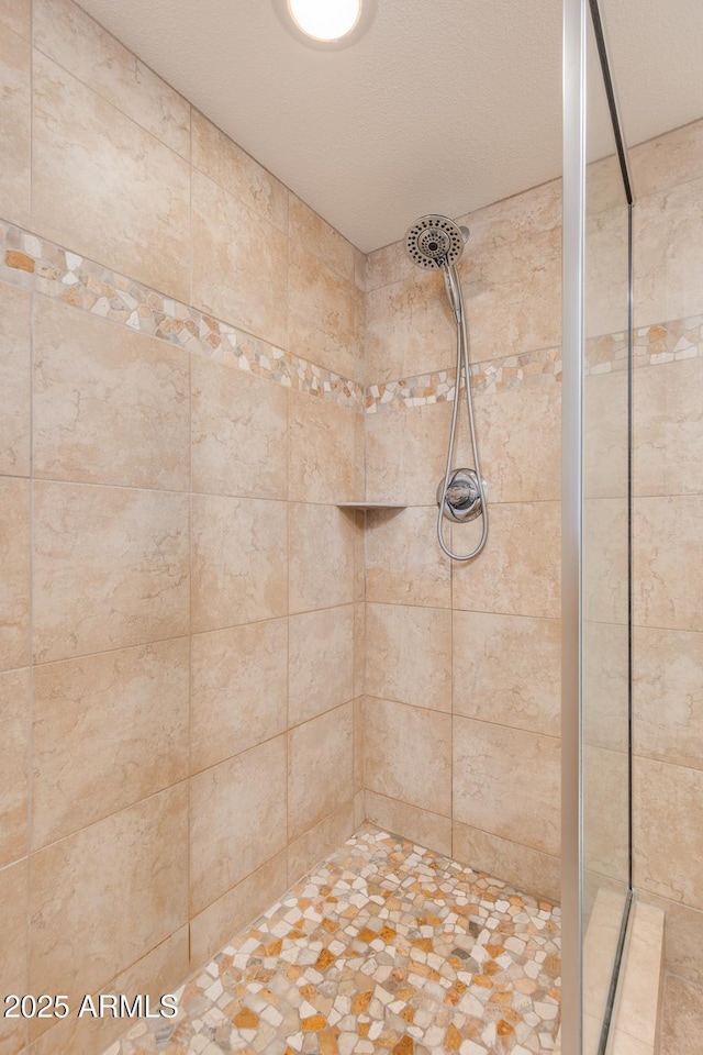 bathroom with a tile shower