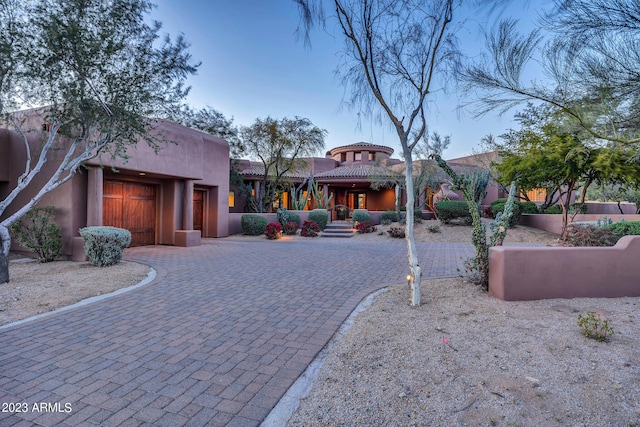 pueblo-style home featuring a garage