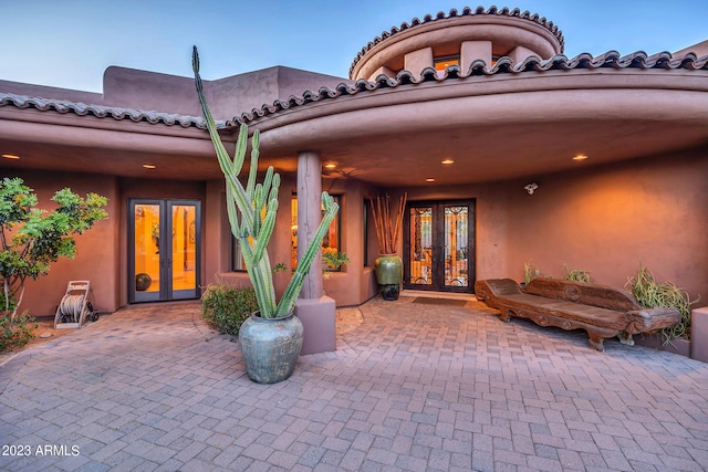 entrance to property with a patio and french doors