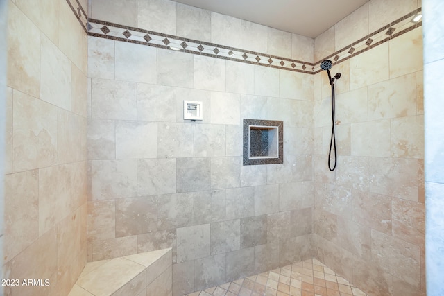 bathroom with tiled shower