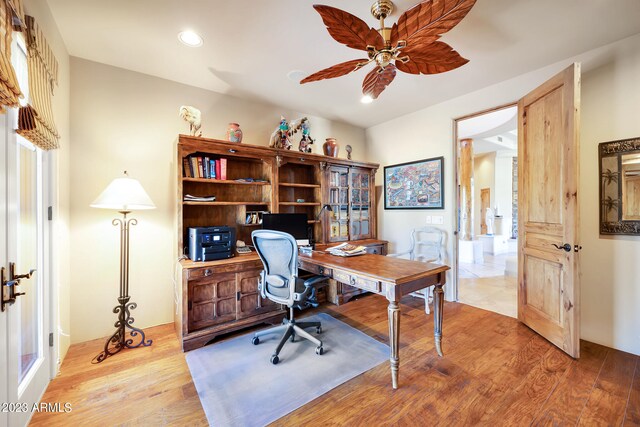 office space with ceiling fan and light hardwood / wood-style flooring