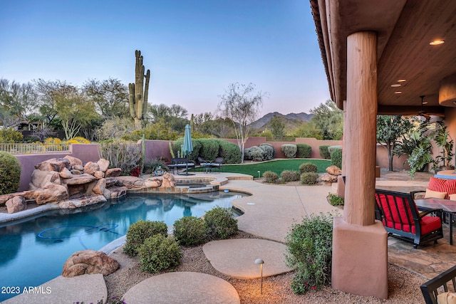 view of pool with a mountain view, an in ground hot tub, and a patio