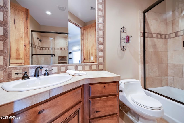 full bathroom with vanity, toilet, bath / shower combo with glass door, and backsplash