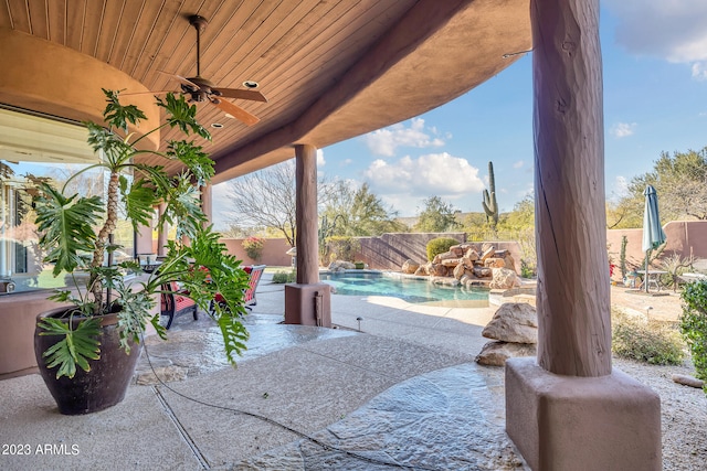 view of patio featuring a fenced in pool and ceiling fan