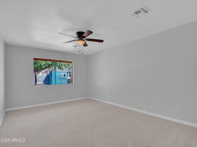 unfurnished room featuring ceiling fan and carpet flooring