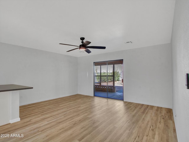 spare room featuring light hardwood / wood-style floors and ceiling fan