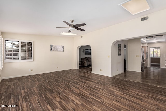 unfurnished living room with dark wood-type flooring and ceiling fan