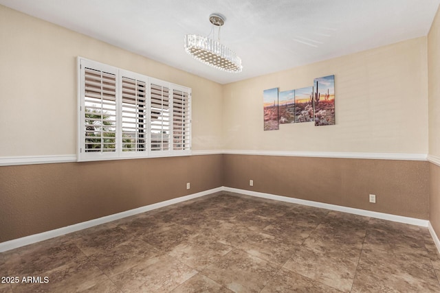 empty room with an inviting chandelier