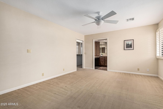 carpeted empty room with ceiling fan