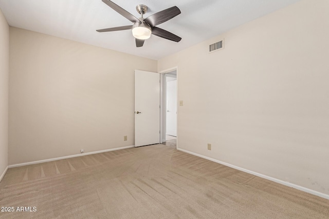 spare room with light colored carpet and ceiling fan