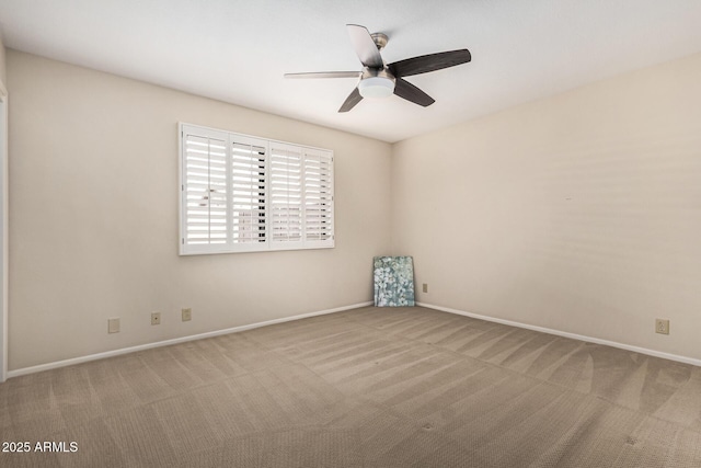 spare room with light colored carpet and ceiling fan