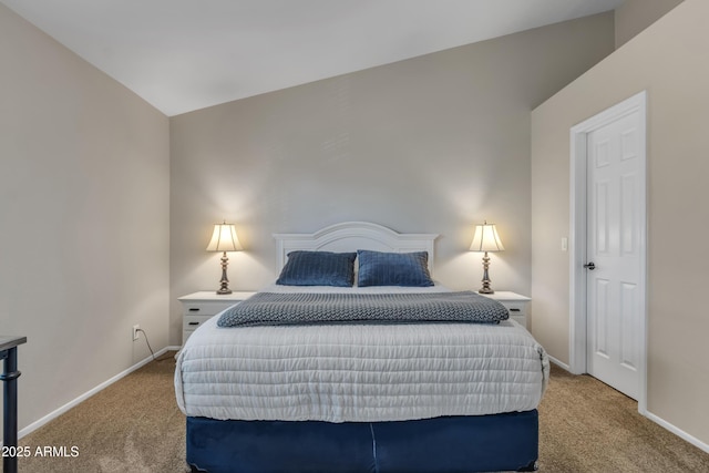 carpeted bedroom with baseboards and vaulted ceiling
