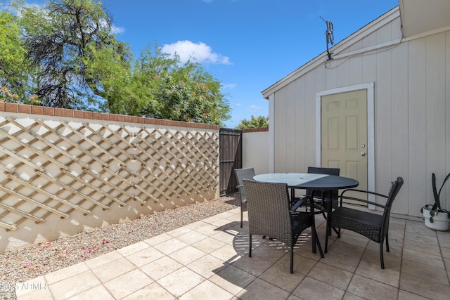 view of patio with fence and outdoor dining space
