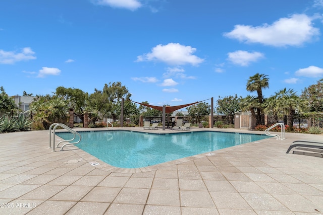 pool with fence and a patio area