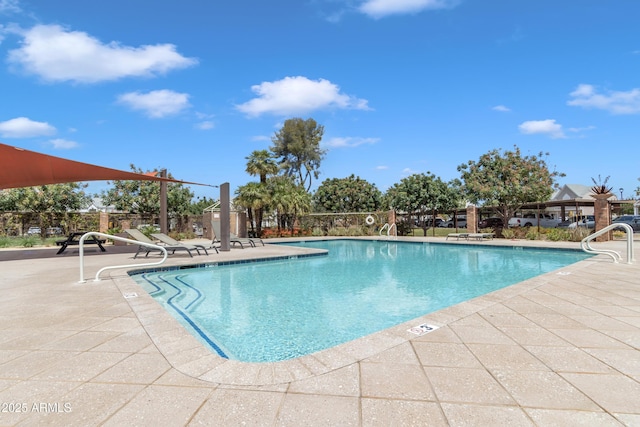 community pool featuring fence and a patio