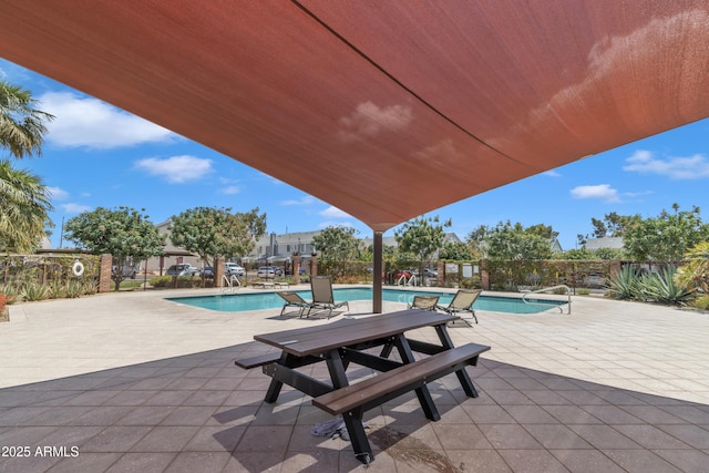 pool with fence and a patio