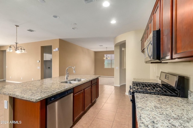 kitchen with pendant lighting, sink, light tile patterned flooring, stainless steel appliances, and a chandelier