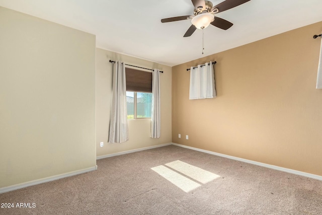 unfurnished room with carpet and ceiling fan