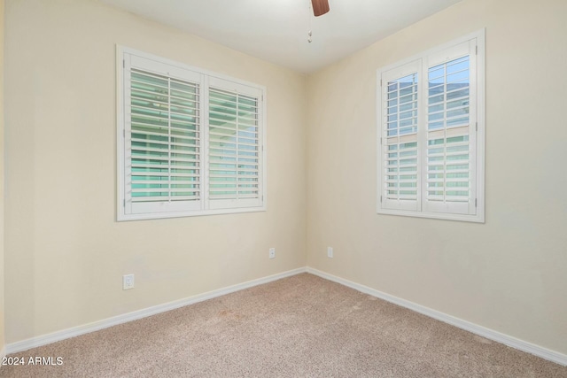 carpeted empty room featuring ceiling fan