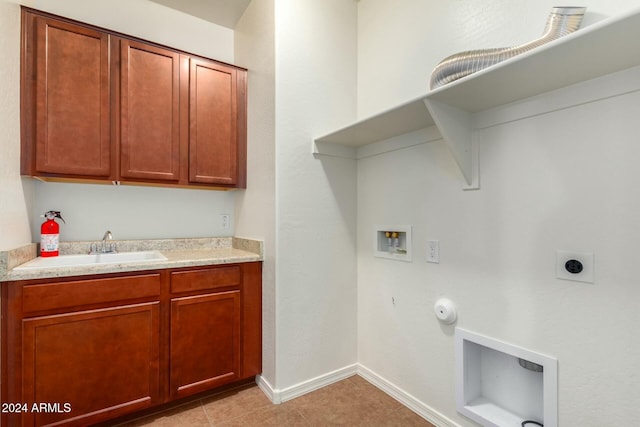 clothes washing area featuring sink, electric dryer hookup, gas dryer hookup, hookup for a washing machine, and light tile patterned floors