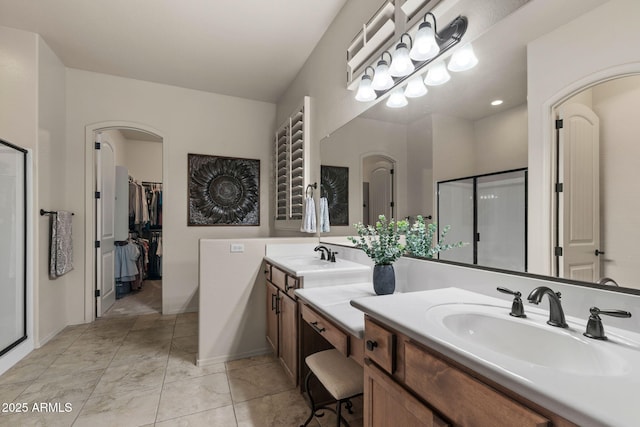 8633 E Kael Cir, Mesa, AZ 85207 - bathroom with double vanity, a shower stall, and a walk in closet