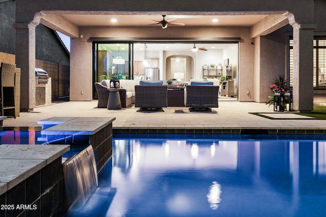 8633 E Kael Cir, Mesa, AZ 85207 - swimming pool featuring a ceiling fan, a patio, an outdoor hangout area, and an outdoor kitchen