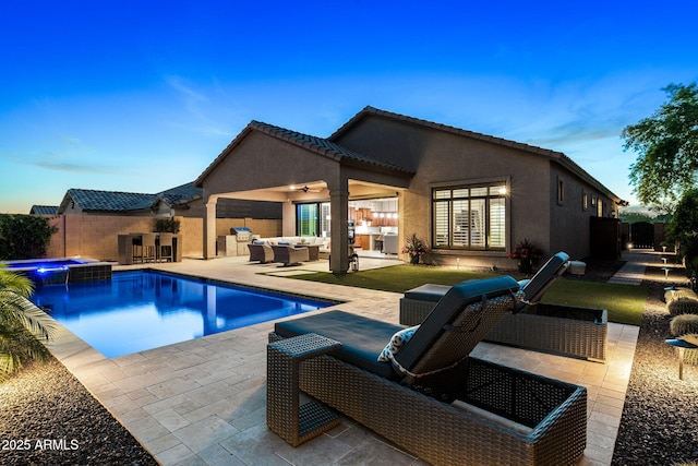 8633 E Kael Cir, Mesa, AZ 85207 - back of property with outdoor lounge area, a ceiling fan, a fenced backyard, and a pool with connected hot tub