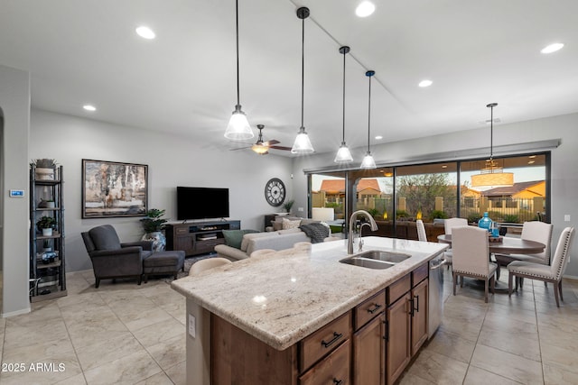 8633 E Kael Cir, Mesa, AZ 85207 - kitchen featuring a sink, decorative light fixtures, light stone counters, a center island with sink, and recessed lighting
