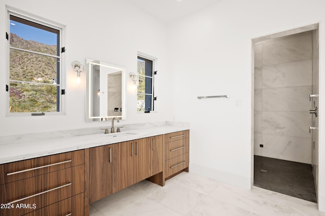 bathroom featuring vanity and a tile shower