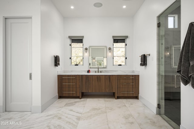 bathroom with vanity and a shower with shower door