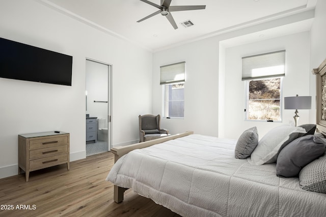 bedroom with hardwood / wood-style flooring, ornamental molding, and ceiling fan