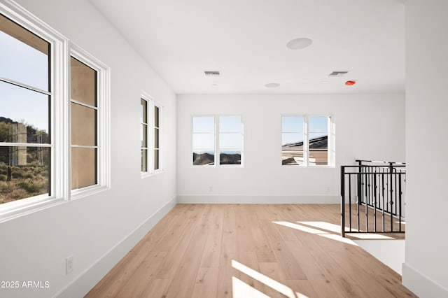 unfurnished room with light hardwood / wood-style floors