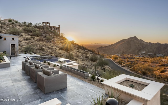 patio terrace at dusk with a mountain view