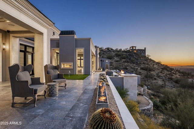 patio terrace at dusk with an outdoor fire pit