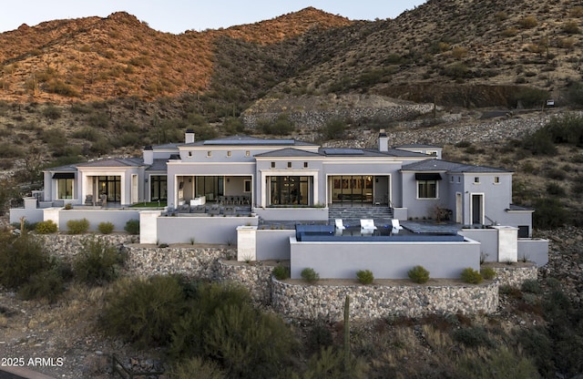 back of property featuring a mountain view