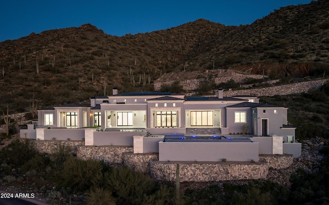 back of house with a mountain view