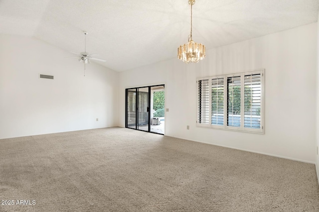 carpeted empty room featuring vaulted ceiling, ceiling fan with notable chandelier, and a healthy amount of sunlight