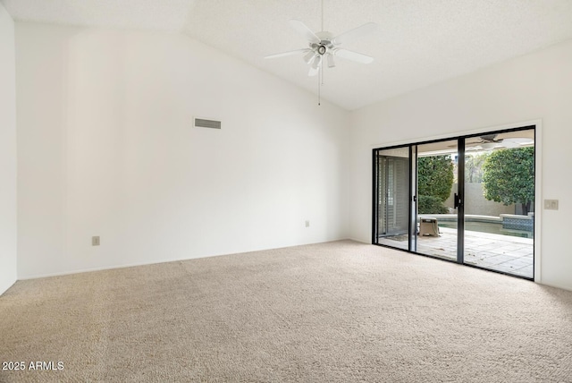 carpeted empty room with high vaulted ceiling and ceiling fan