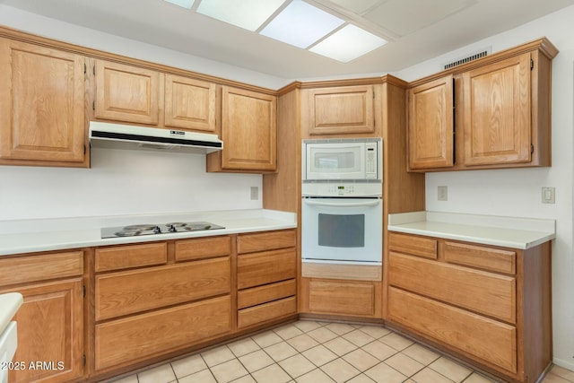 kitchen with white appliances and light tile patterned floors