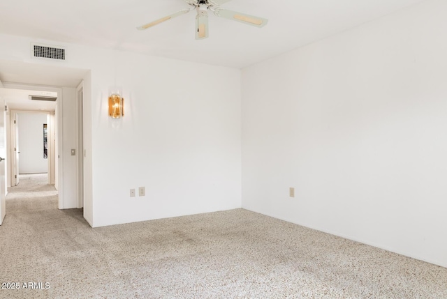 empty room featuring ceiling fan and light carpet