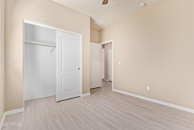 unfurnished bedroom featuring ceiling fan, a closet, and light hardwood / wood-style flooring