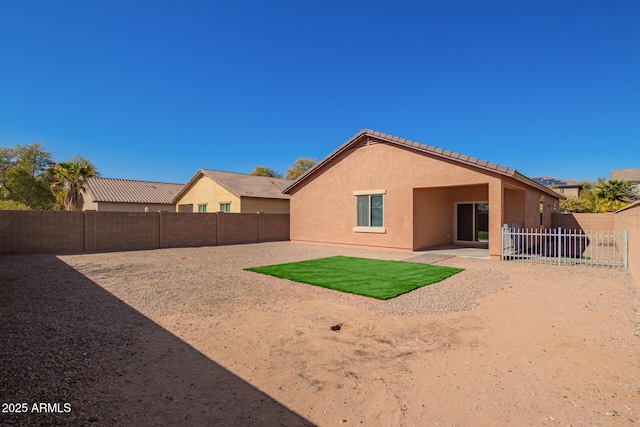 back of house with a patio