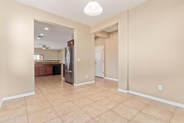 tiled empty room featuring ceiling fan