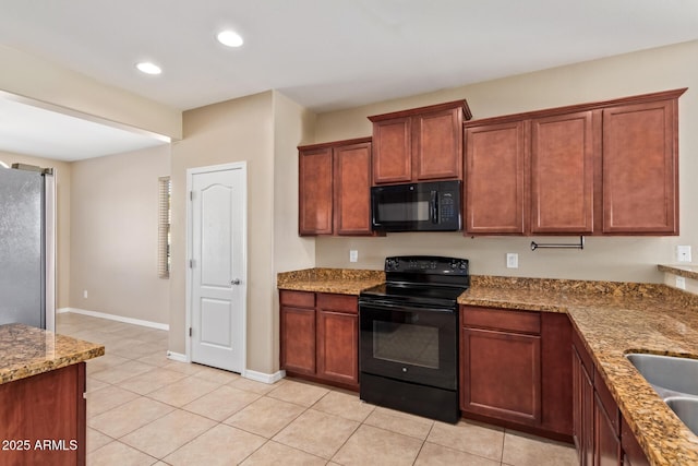 kitchen with light tile patterned floors, light stone counters, and black appliances