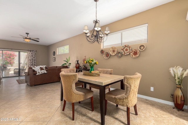 dining space with light tile patterned floors, baseboards, and ceiling fan with notable chandelier