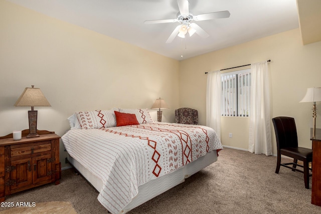 carpeted bedroom featuring baseboards and a ceiling fan