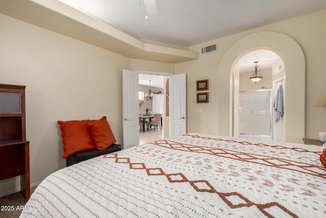 bedroom featuring ceiling fan, arched walkways, and visible vents