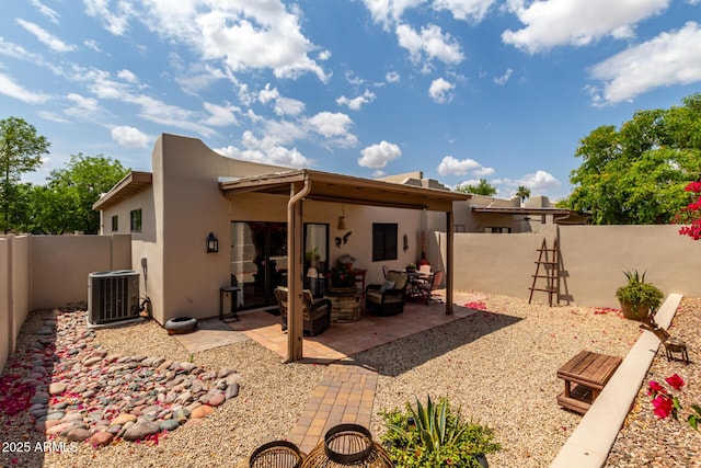 back of house featuring a fenced backyard, a patio area, stucco siding, and cooling unit